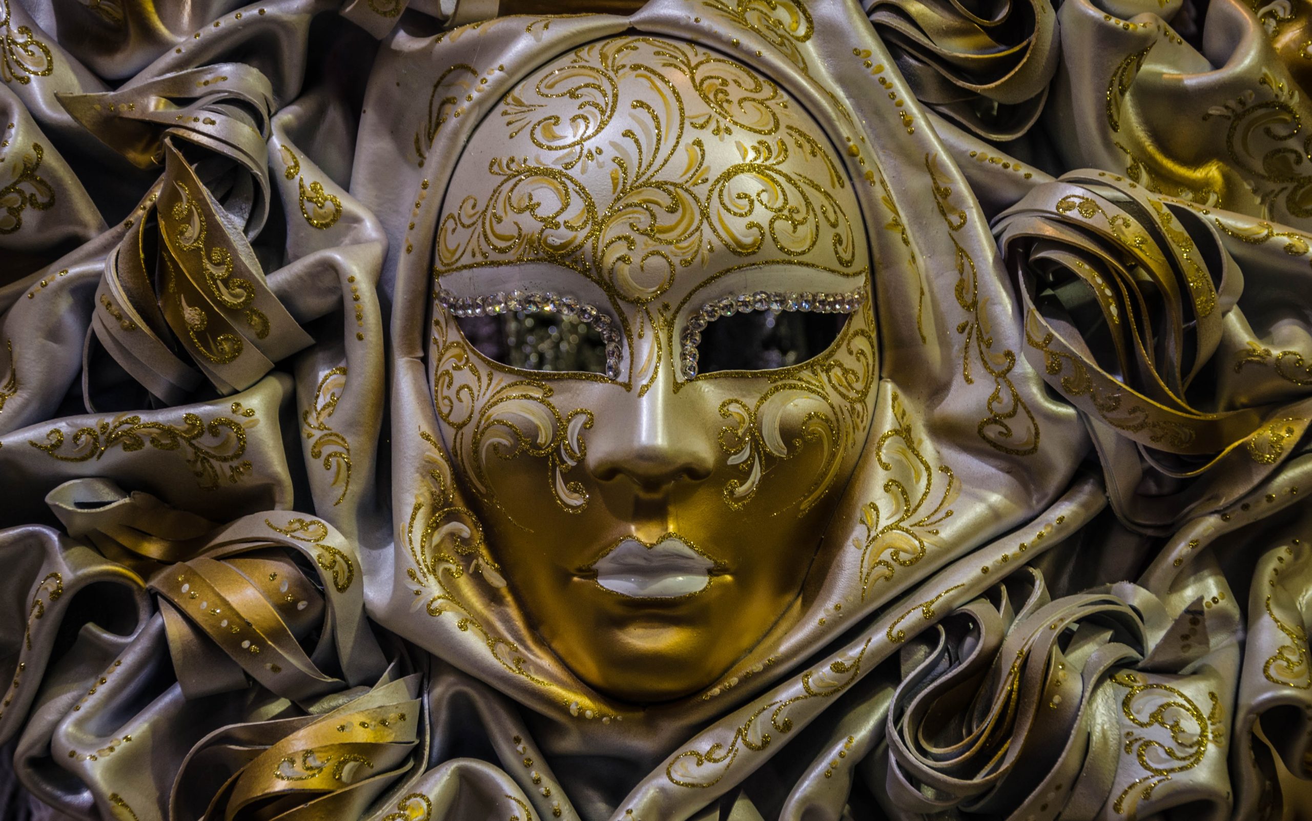 Venetian mask on bed of satin.