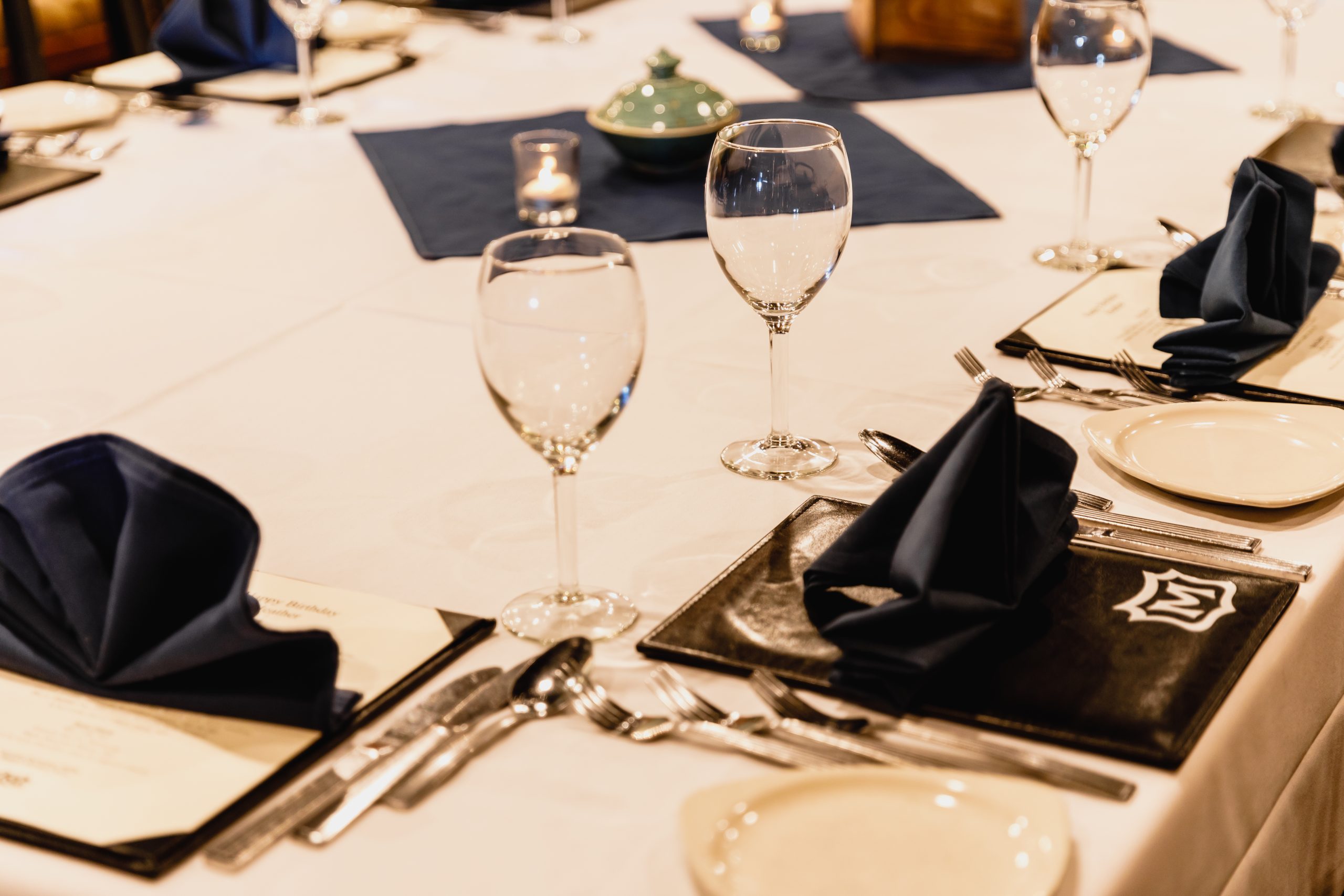 An elegant table setting at a high-end restaurant prepared for a private event.