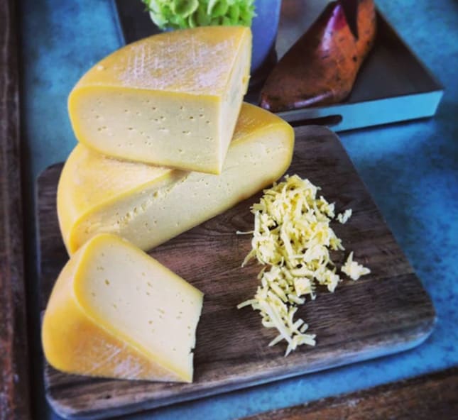 Blocks of cheese on cutting board